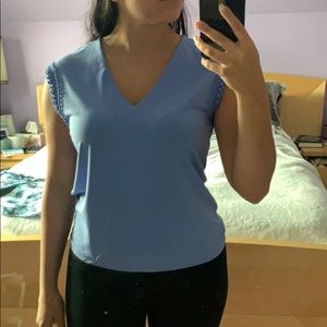 Periwinkle blouse with crochet trimming on sleeves